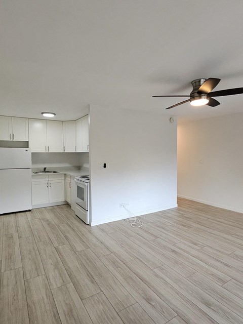 Punahou Circle kitchen with white appliances and wooden floors.