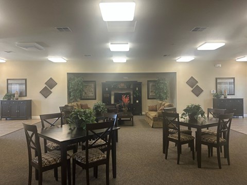 A dining room with a table set for six.