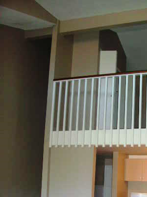 Coconut Inn living area, stairs, and loft railing Coconut Inn living area, stairs, and loft railing