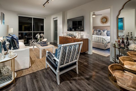 A modern bedroom with a large bed and a chair with a blue and white pattern.