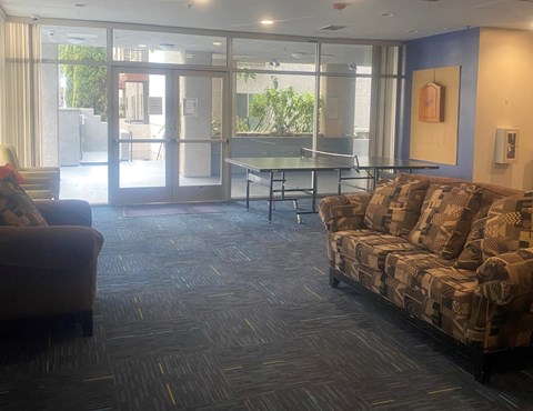 an empty living room with couches and a table