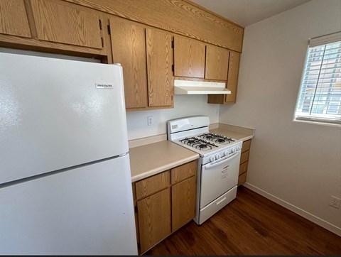 a kitchen with a stove and a refrigerator
