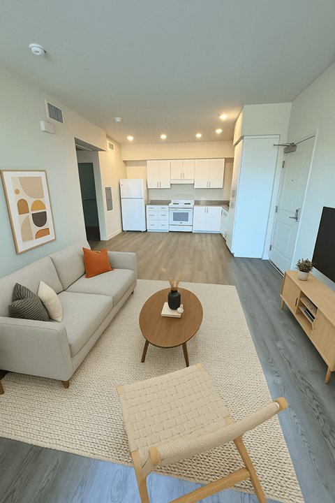 A living room with a grey couch and a coffee table.