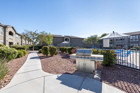 A sunny day at a residential area with a pool and a BBQ grill.