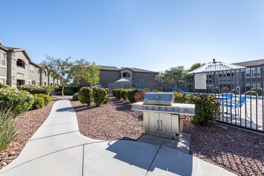 A sunny day at a residential area with a pool and a BBQ grill.