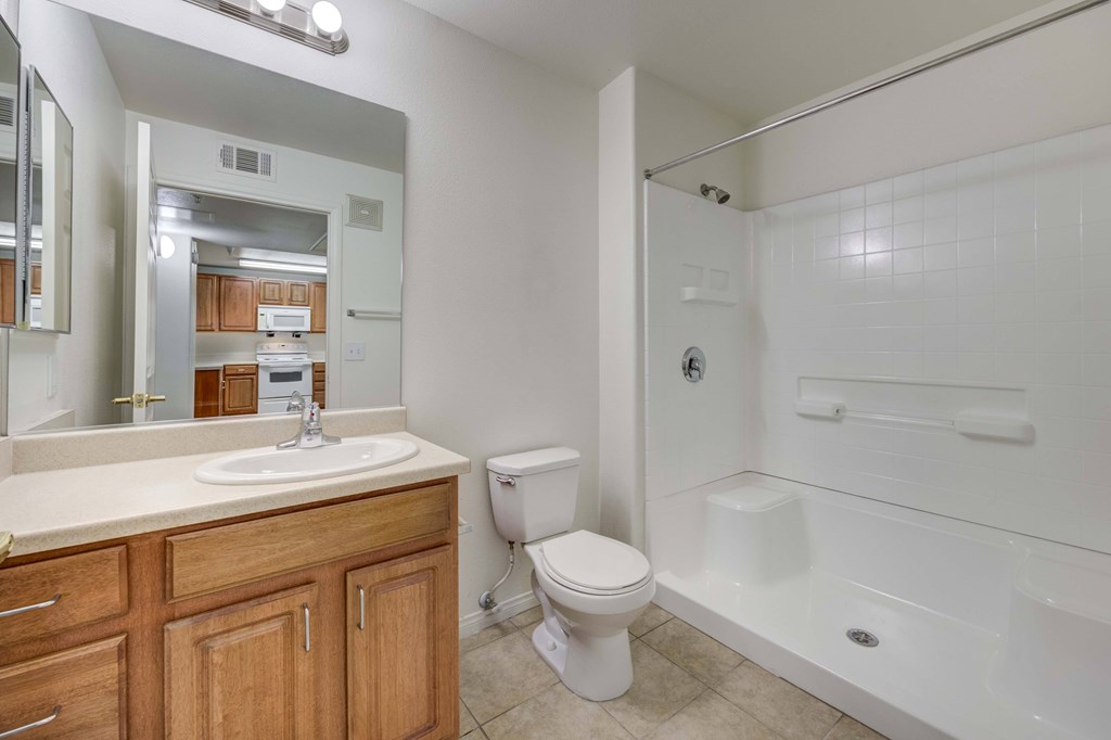 A white bathroom with a toilet, sink, and bathtub.