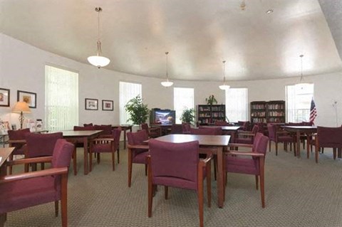 a large dining room with tables and chairs