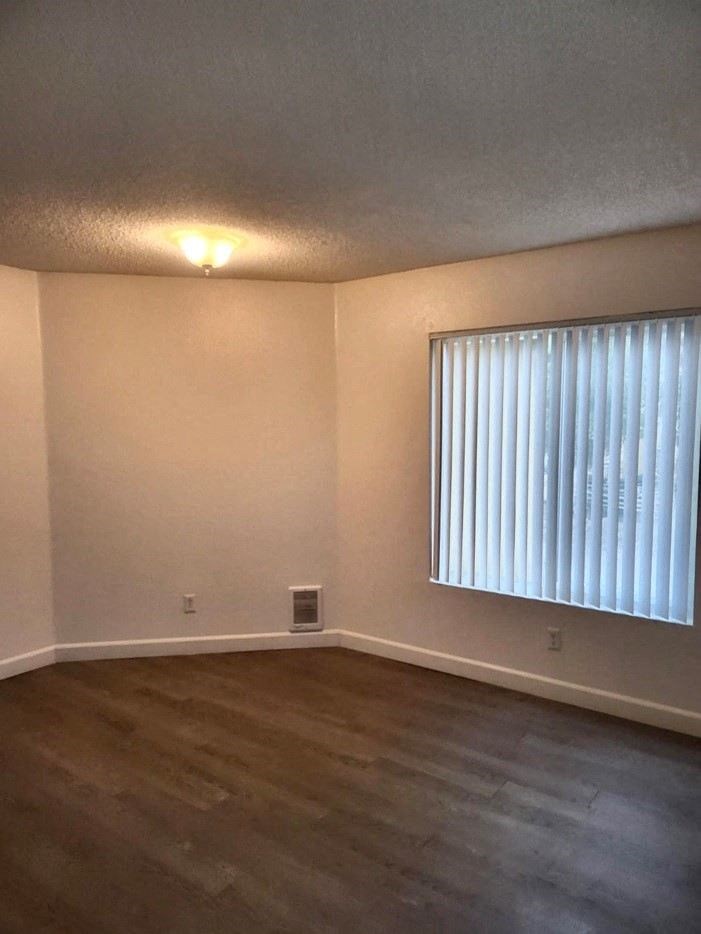 A room with a window and a light on.