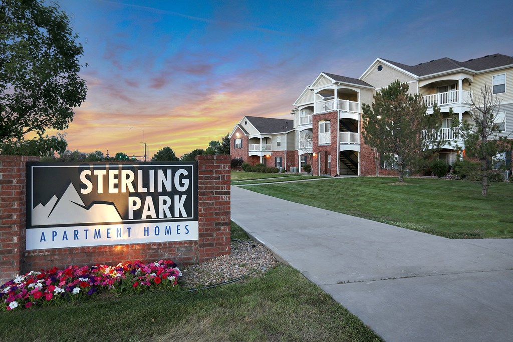 Sterling Park Apartment Homes sign with a sunset in the background.