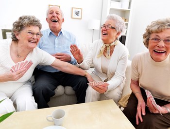 Stock Image of 4 seniors laughing playing cards - Photo Gallery 4