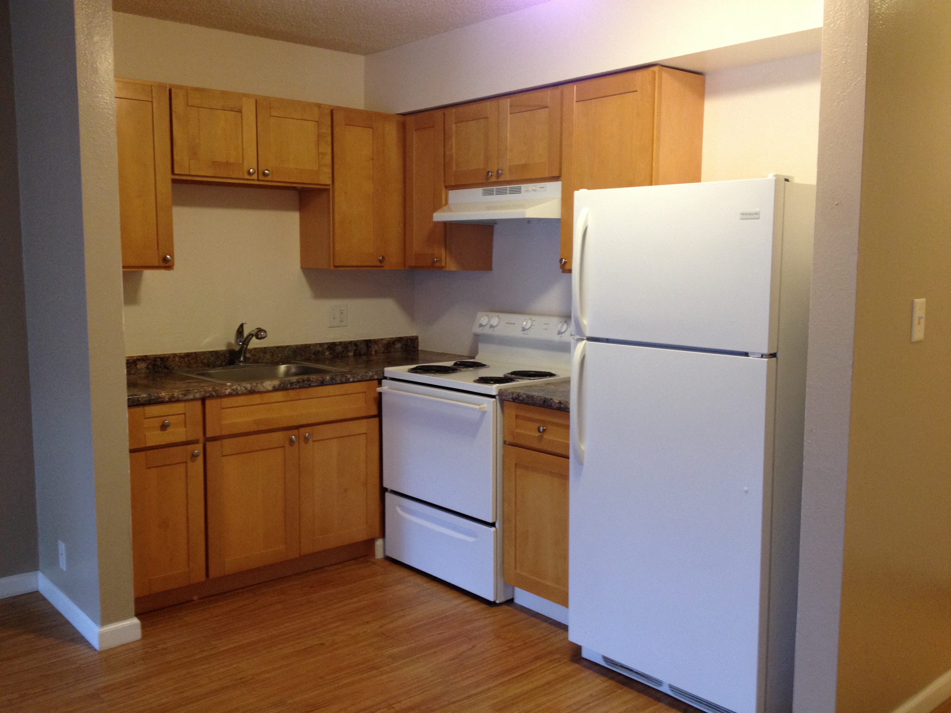 Coconut Inn kitchen area with appliances, cabinets, and counters