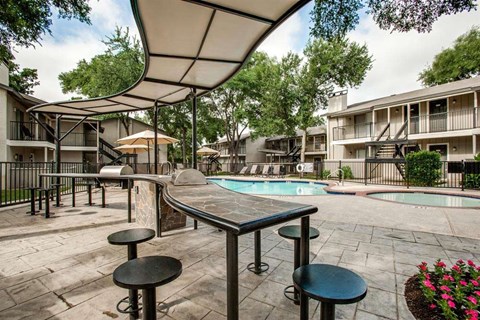 Courtyards of Roses Apartments pool area with shaded seating