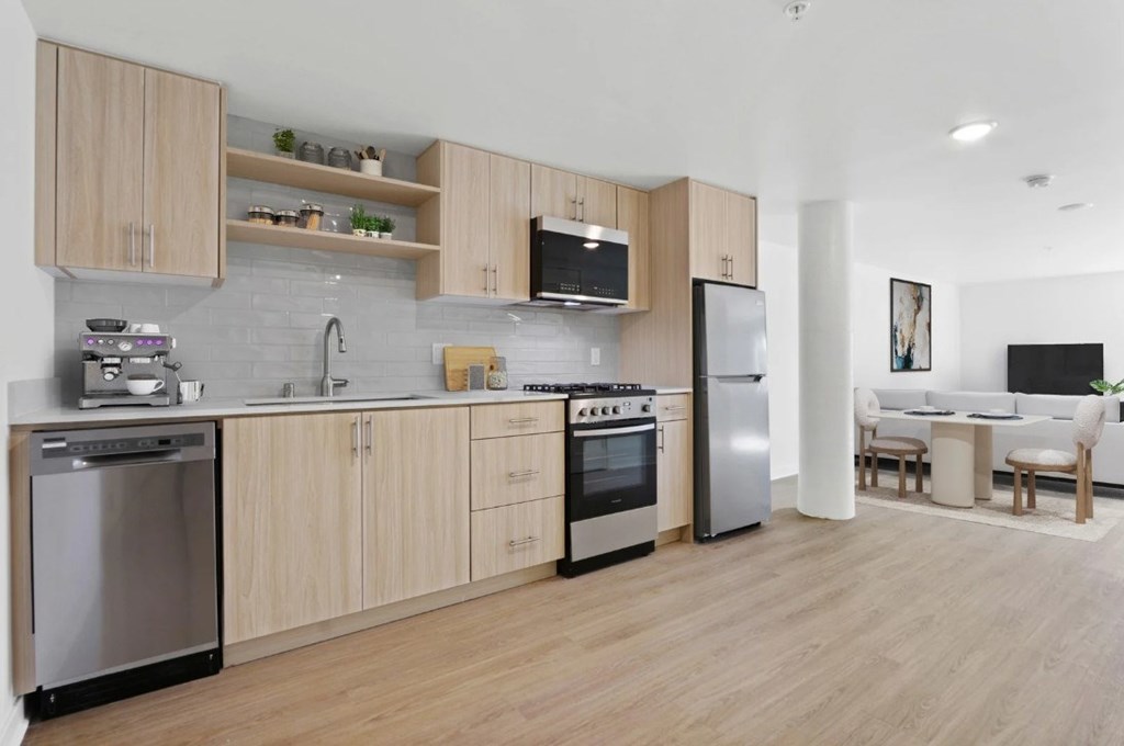 A modern kitchen with wooden cabinets and stainless steel appliances.