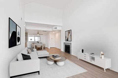 A modern living room with a white couch and a coffee table.