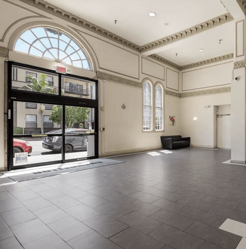 the lobby of a building with a large glass door