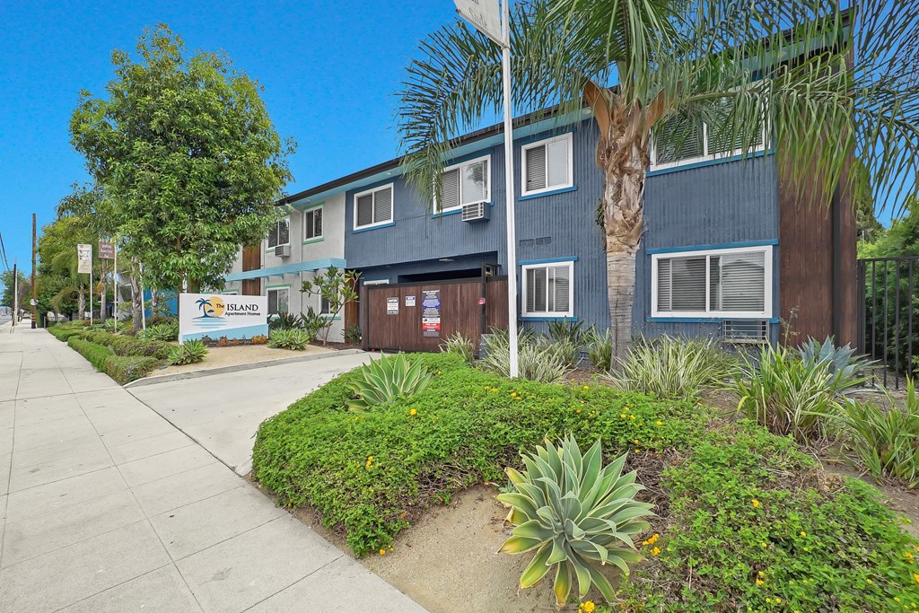 A blue building with a sign that says "BLOOM" in front of it.