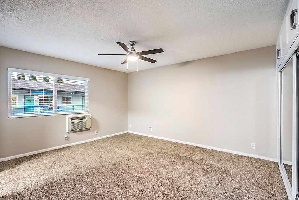 The Island Apartments unfurnished bedroom with ceiling fan