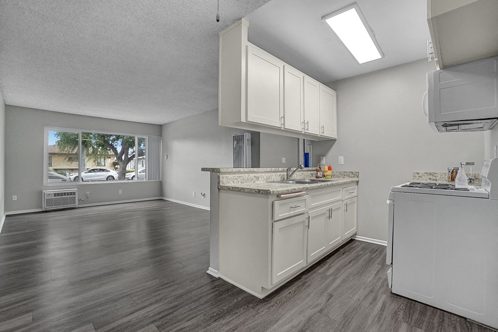 a kitchen and living room with a large window