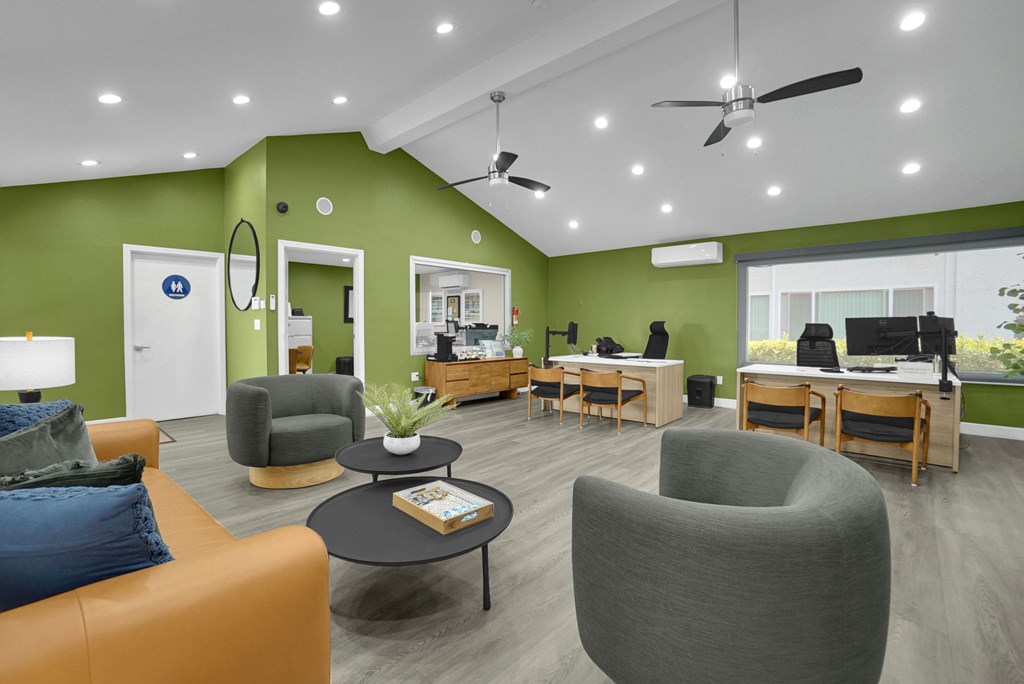 A living room with a green wall and a couch.