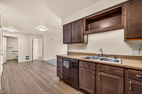 A kitchen with brown cabinets and a sink.