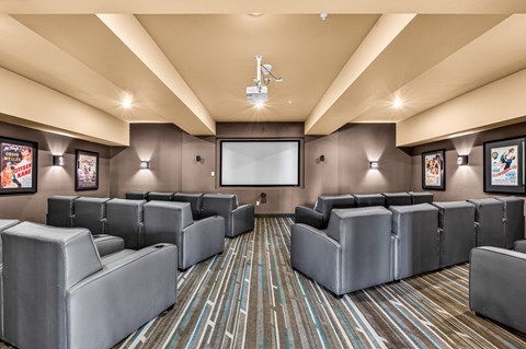 A room with grey couches and a striped carpet.