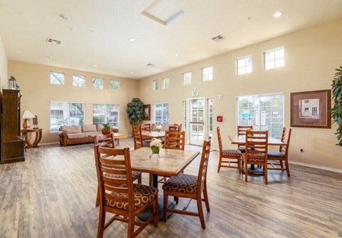 A dining room with a wooden table and chairs.