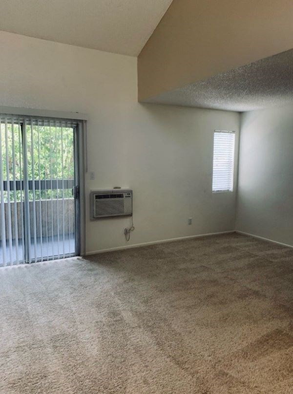 A room with a window and a sliding glass door.