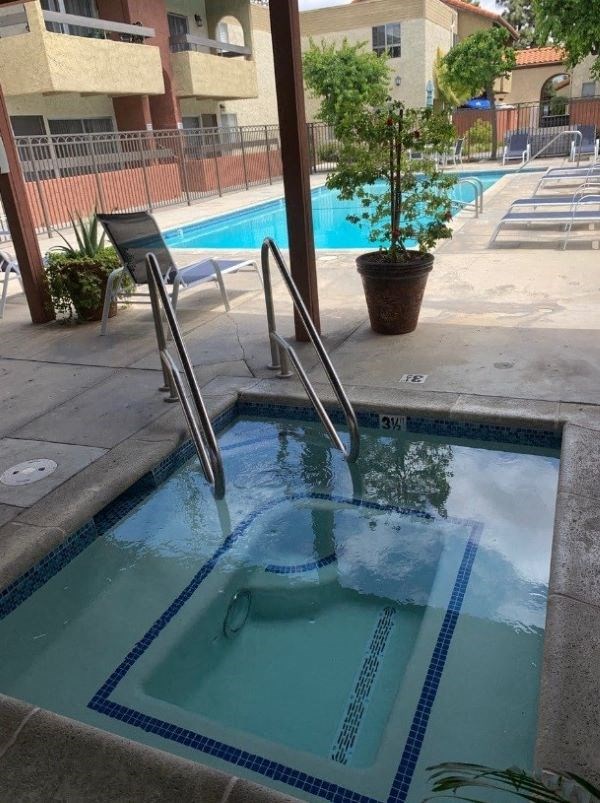 A small pool with a ladder in the middle of it.
