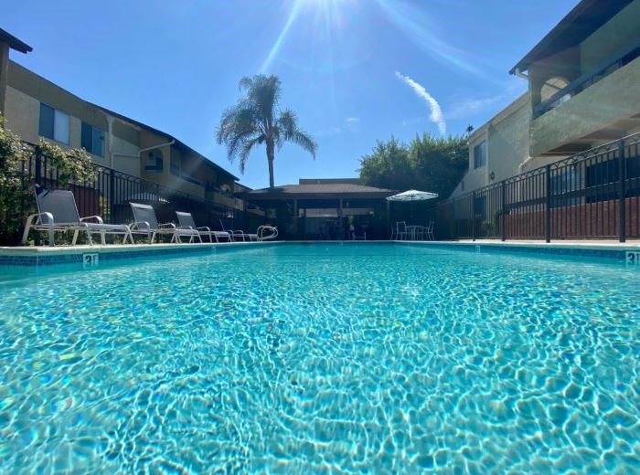 A swimming pool with sunlight reflecting on the water.