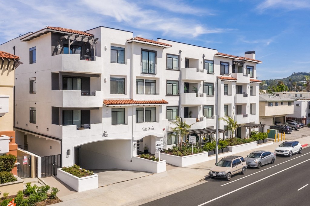 a large white building with a parking lot in front of it