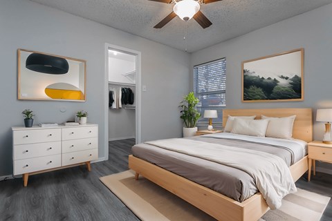 a bedroom with a bed and a ceiling fan
