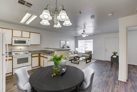 A modern kitchen with a dining table and chairs.