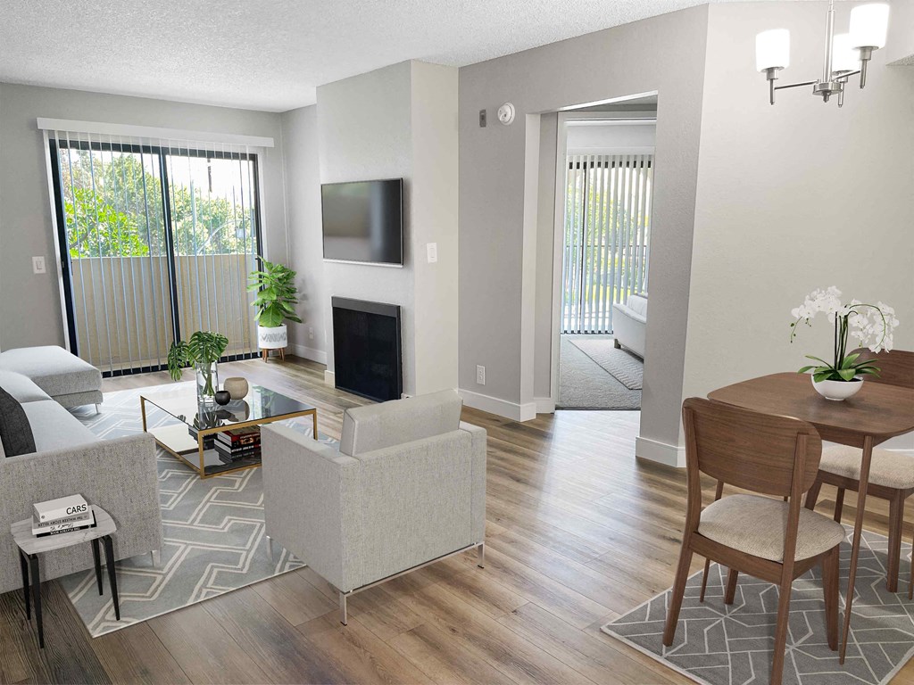 a living room with a fireplace and a table and chairs