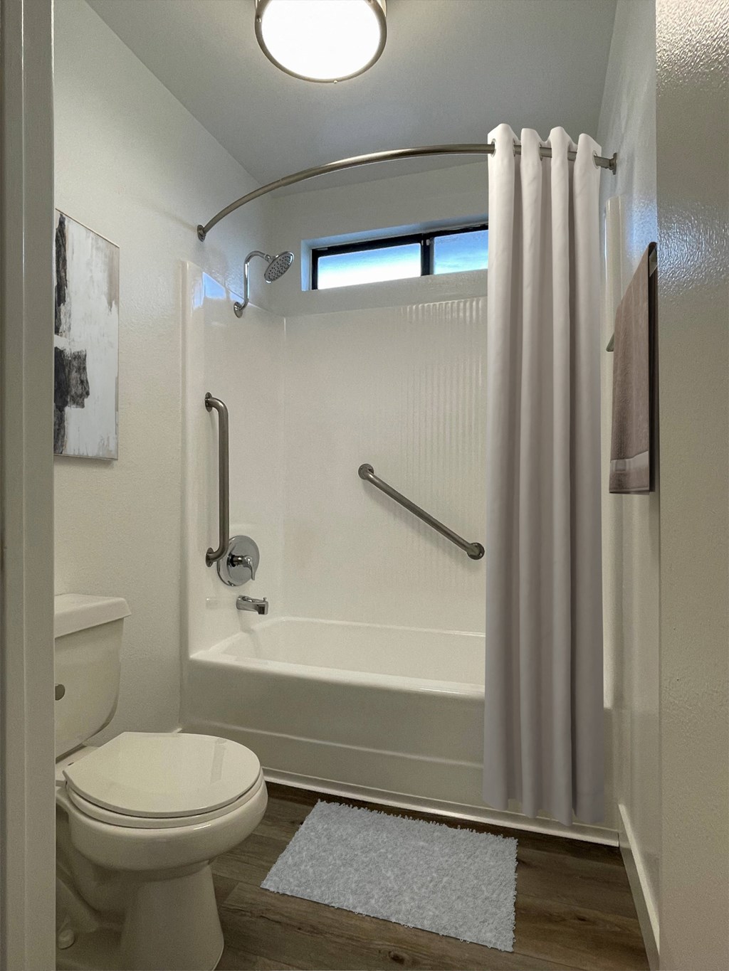 a bathroom with a toilet and a tub and a shower curtain