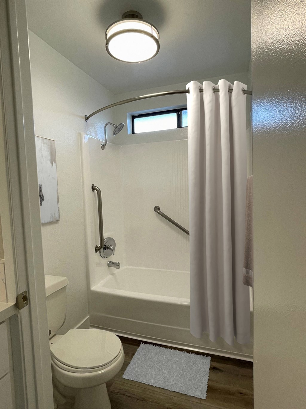 a bathroom with a shower and a toilet and a curtain