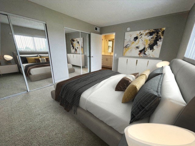 a bedroom with a large bed and a large mirror