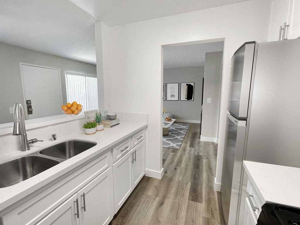 a kitchen with white cabinets and stainless steel appliances