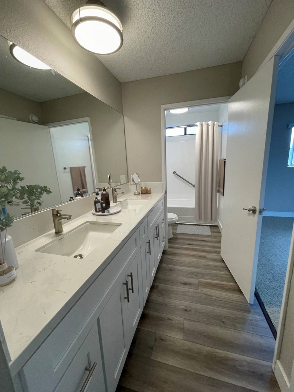 a bathroom with white cabinets and a sink and a mirror