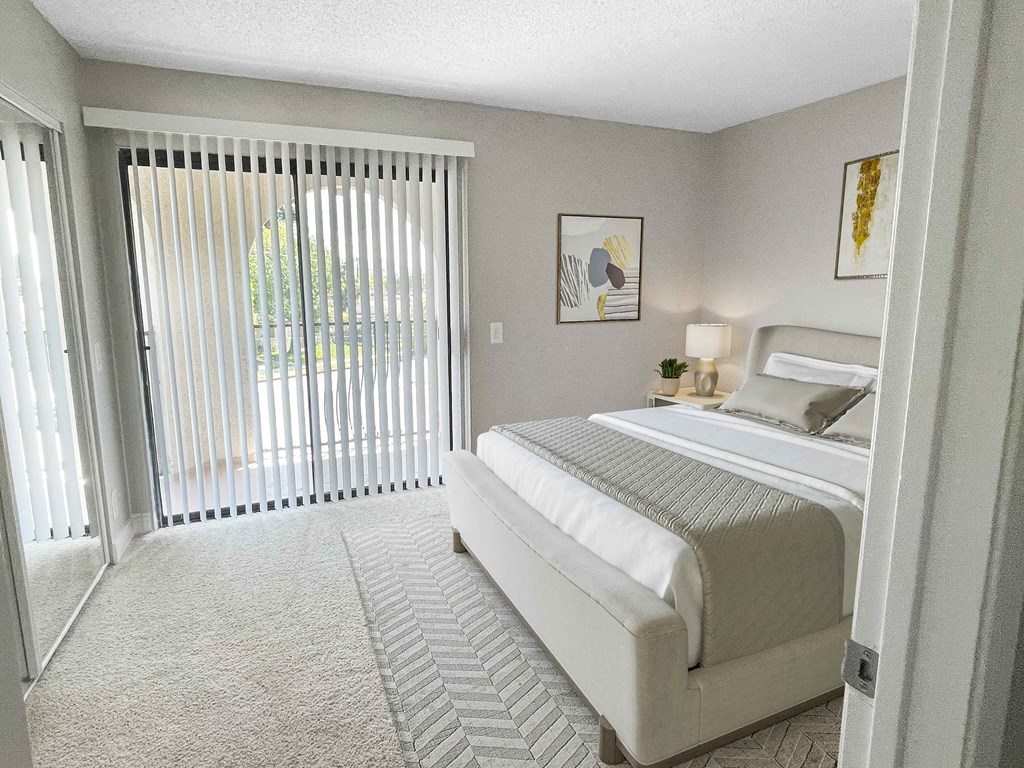 a bedroom with a bed and a sliding glass door