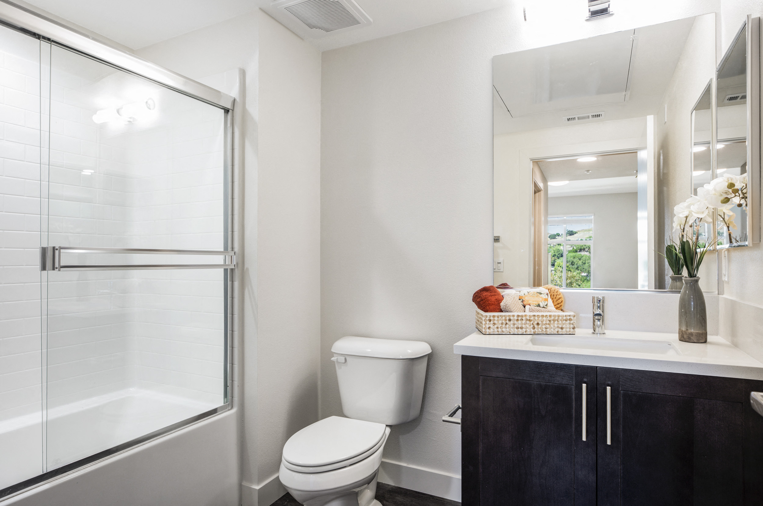 YOLO East bathroom vanity, toilet, and shower