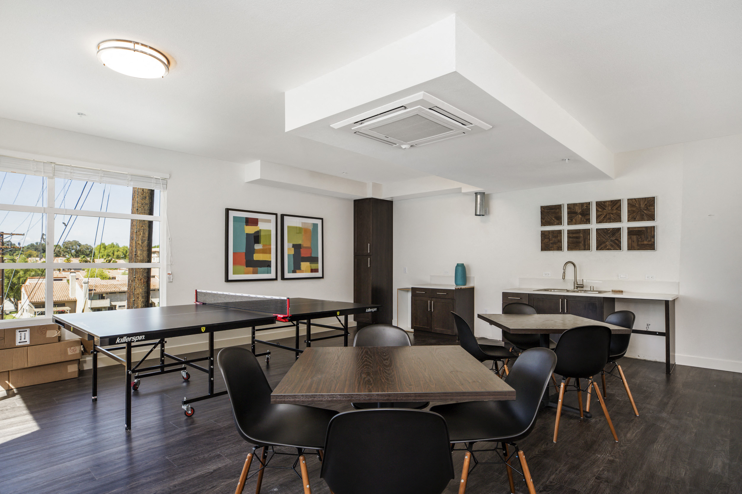 YOLO East interior room with ping pong and dining tables