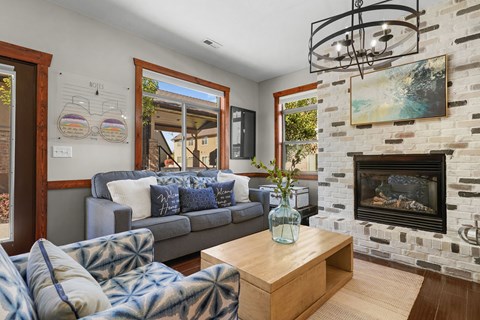A living room with a grey couch and a wooden coffee table.