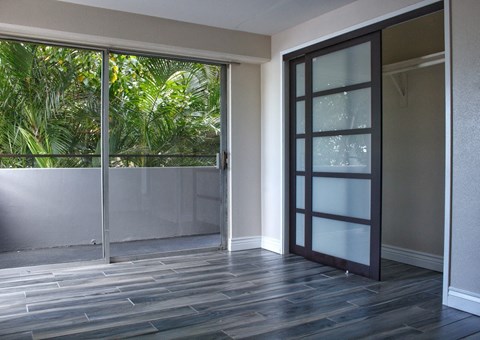 a living room with a glass door and a balcony