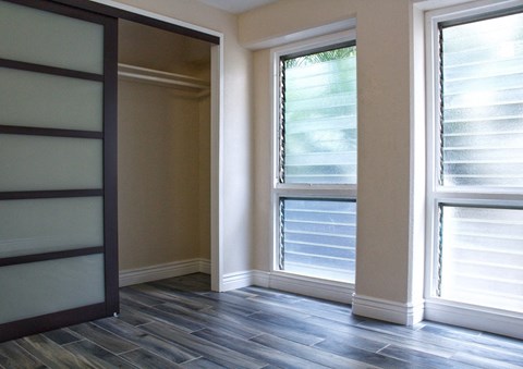 a living room with a window and a wood floor