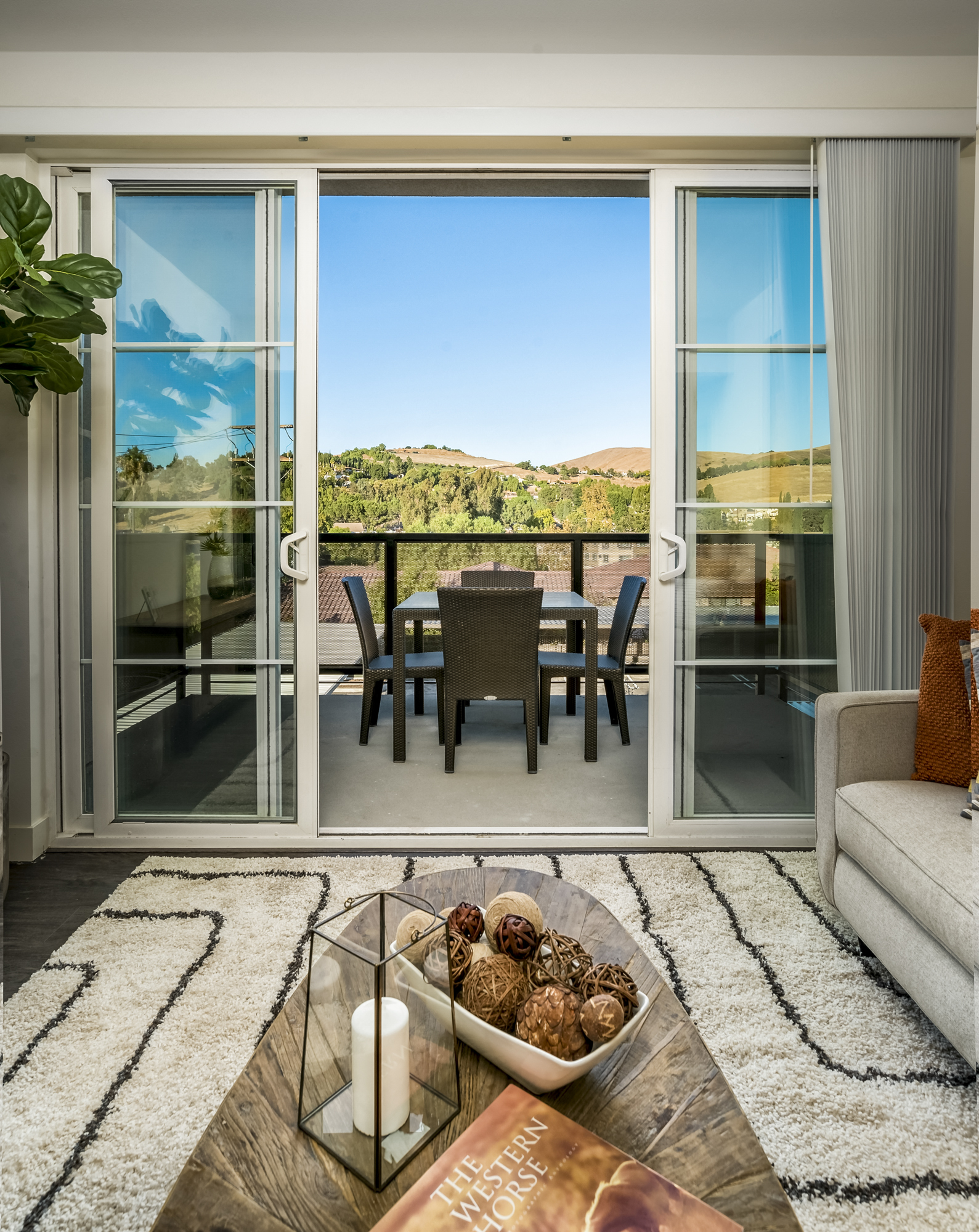 YOLO East furnished living room with balcony