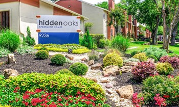 Hidden Oaks Apartment Homes garden and signage - Photo Gallery 8