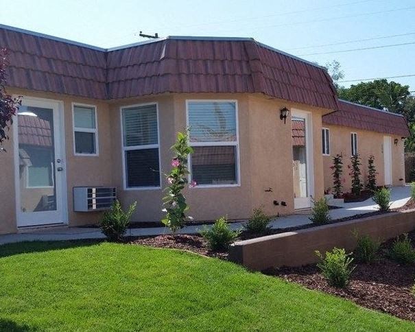 Limoncello Apartments exterior building and grass lawn