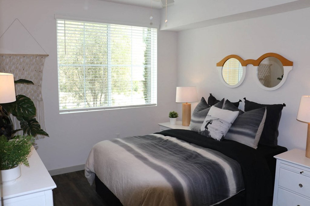 a bedroom with a bed and a window