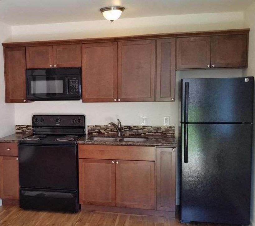 a kitchen with a stove and a refrigerator