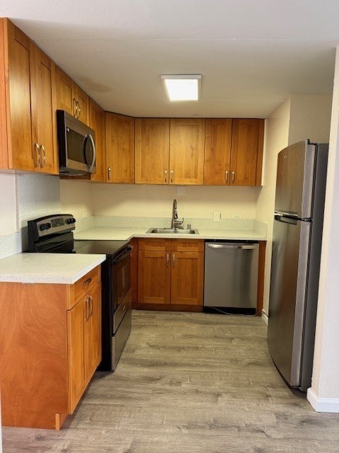 A kitchen with wooden cabinets and a refrigerator.